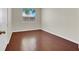 This bedroom features wood floors, a window, and neutral walls at 6032 Red Glitter St, North Las Vegas, NV 89031