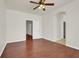 Large bedroom with hardwood floors, ceiling fan and arched doorways at 6032 Red Glitter St, North Las Vegas, NV 89031