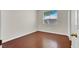Bedroom with wood floors, neutral walls, white trim, and a window at 6032 Red Glitter St, North Las Vegas, NV 89031