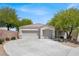 Charming single-story home featuring a three-car garage and a well-maintained front yard with mature trees at 6032 Red Glitter St, North Las Vegas, NV 89031