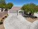Charming single-story home boasting a three-car garage and a well-maintained, curved driveway at 6032 Red Glitter St, North Las Vegas, NV 89031