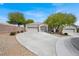 Charming single-story home featuring a three-car garage and a well-maintained front yard with mature trees at 6032 Red Glitter St, North Las Vegas, NV 89031
