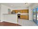 Eat-in kitchen features stainless steel appliances and hardwood cabinets with backyard views at 6032 Red Glitter St, North Las Vegas, NV 89031