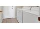Laundry room with tile floors, white washer and dryer, and white door at 6032 Red Glitter St, North Las Vegas, NV 89031