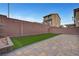 Private backyard featuring brick walls, pavers, and low maintenance artificial grass at 6056 Atlantis Dream Ave, Las Vegas, NV 89139