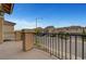 Balcony view features wrought iron railing and charming neighborhood street at 6056 Atlantis Dream Ave, Las Vegas, NV 89139