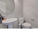 Half bathroom with pedestal sink and stylish wall mirror at 6056 Atlantis Dream Ave, Las Vegas, NV 89139