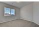 Bedroom with a window and neutral carpeted floors at 6056 Atlantis Dream Ave, Las Vegas, NV 89139