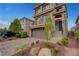 Beautiful stucco home with well-kept landscaping and a brick driveway at 6056 Atlantis Dream Ave, Las Vegas, NV 89139