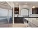 Modern kitchen with stainless steel refrigerator, dark wood cabinets, and sleek appliances at 6056 Atlantis Dream Ave, Las Vegas, NV 89139