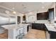 Modern kitchen with stainless steel appliances, center island with seating, and dark cabinetry at 6056 Atlantis Dream Ave, Las Vegas, NV 89139