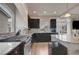 Well-equipped kitchen featuring dark cabinets, granite countertops, and stainless steel appliances at 6056 Atlantis Dream Ave, Las Vegas, NV 89139