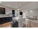 Open-concept kitchen and living area with island seating, stainless appliances, and a cozy atmosphere at 6056 Atlantis Dream Ave, Las Vegas, NV 89139