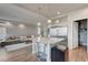 Spacious open layout kitchen features a large island, stainless steel fridge, and a walk-in pantry at 6056 Atlantis Dream Ave, Las Vegas, NV 89139