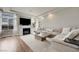 Cozy living room with fireplace, plush sofa, and plenty of natural light at 6056 Atlantis Dream Ave, Las Vegas, NV 89139