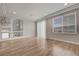 Bright living room featuring wood floors, large windows, and neutral paint at 6056 Atlantis Dream Ave, Las Vegas, NV 89139
