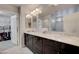 Elegant bathroom with double sinks, marble countertops, and access to a walk-in closet at 6056 Atlantis Dream Ave, Las Vegas, NV 89139