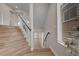 Elegant wood staircase with modern railing leading to the upper level of the home at 6056 Atlantis Dream Ave, Las Vegas, NV 89139