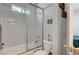 A bright bathroom features a tub shower with a glass door, white tile, and a toilet at 6271 Sunset Spring Ave, Las Vegas, NV 89122