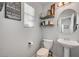 Charming half-bathroom with pedestal sink, floating shelves and wall decor at 6271 Sunset Spring Ave, Las Vegas, NV 89122