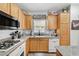 Well-lit kitchen featuring light wood cabinets and speckled granite countertops at 6271 Sunset Spring Ave, Las Vegas, NV 89122