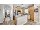 Kitchen island with granite countertops, stainless steel appliances, and wood-look flooring at 6271 Sunset Spring Ave, Las Vegas, NV 89122