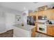Kitchen island with granite countertop, stainless steel refrigerator, wood-look flooring, and white cabinets at 6271 Sunset Spring Ave, Las Vegas, NV 89122