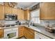 Kitchen with stainless steel appliances, granite countertops, white subway tile backsplash, and wood-look flooring at 6271 Sunset Spring Ave, Las Vegas, NV 89122