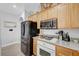 Kitchen with stainless steel refrigerator, gas range, and wood cabinets at 6271 Sunset Spring Ave, Las Vegas, NV 89122