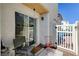 A cozy backyard patio features a sliding glass door, chairs, and an entry gate at 6271 Sunset Spring Ave, Las Vegas, NV 89122