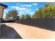 Large, empty backyard featuring a block wall fence and desert landscaping, ready for customization at 6324 Eugene Ave, Las Vegas, NV 89108