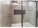 Modern bathroom shower with tile surround, glass door, and shower niche at 6324 Eugene Ave, Las Vegas, NV 89108