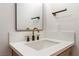 Close-up of bathroom sink with white countertop, matte black faucet, and hardware at 6324 Eugene Ave, Las Vegas, NV 89108