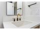 Bathroom with a white sink, quartz countertop, and sleek black and gold fixtures at 6324 Eugene Ave, Las Vegas, NV 89108