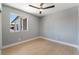 Bedroom with wood-look floors, modern fan, and view of neighborhood at 6324 Eugene Ave, Las Vegas, NV 89108