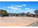Single-story home with a desert landscape, driveway, gate, and a classic red front door at 6324 Eugene Ave, Las Vegas, NV 89108