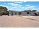 Single-story home with a well-maintained desert landscape, a driveway and a red front door at 6324 Eugene Ave, Las Vegas, NV 89108