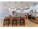 Modern kitchen with white cabinets, stainless steel appliances, marble backsplash, and a stylish island with seating at 6324 Eugene Ave, Las Vegas, NV 89108