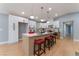 Bright kitchen featuring a large island with seating, white cabinets, modern lighting, and wood-look flooring at 6324 Eugene Ave, Las Vegas, NV 89108