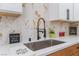 Kitchen sink area with stainless steel sink, marble-look backsplash and modern fixtures at 6324 Eugene Ave, Las Vegas, NV 89108