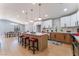 Open-concept kitchen with island seating, stainless appliances, white and wood cabinets, and adjacent dining area at 6324 Eugene Ave, Las Vegas, NV 89108