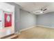 Bright, open living room with wood-look floors, modern fan, and a vibrant red front door at 6324 Eugene Ave, Las Vegas, NV 89108
