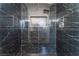 Modern shower featuring black marble tiling, niche shelving, and sleek chrome fixtures at 6324 Eugene Ave, Las Vegas, NV 89108