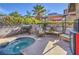 Inviting backyard oasis with heated spa, built-in grill, and cozy covered patio for outdoor enjoyment at 6408 Deadwood Rd, Las Vegas, NV 89108