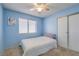 Cozy bedroom with carpeted floors, bright blue walls, and plenty of natural light at 6408 Deadwood Rd, Las Vegas, NV 89108