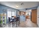 Eat-in kitchen with a dining area offering natural light, stylish flooring, and updated cabinets at 6408 Deadwood Rd, Las Vegas, NV 89108