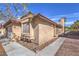 Side view of a house with well-maintained stucco exterior and rock landscaping for low maintenance at 6408 Deadwood Rd, Las Vegas, NV 89108