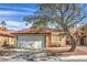 Charming single-story home with a well-manicured lawn, mature tree, and inviting curb appeal at 6408 Deadwood Rd, Las Vegas, NV 89108