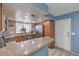 Updated kitchen boasting granite countertops, stainless steel appliances, and stylish tile backsplash at 6408 Deadwood Rd, Las Vegas, NV 89108