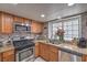 Modern kitchen with granite countertops, stainless steel appliances, and sleek oak cabinetry at 6408 Deadwood Rd, Las Vegas, NV 89108